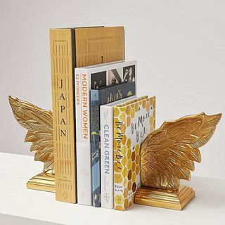 Capete de cărți de aur cu aripi metalice